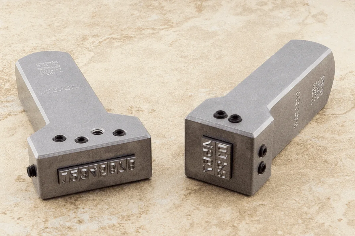 Interchangeable steel type holders with changeable character inserts.