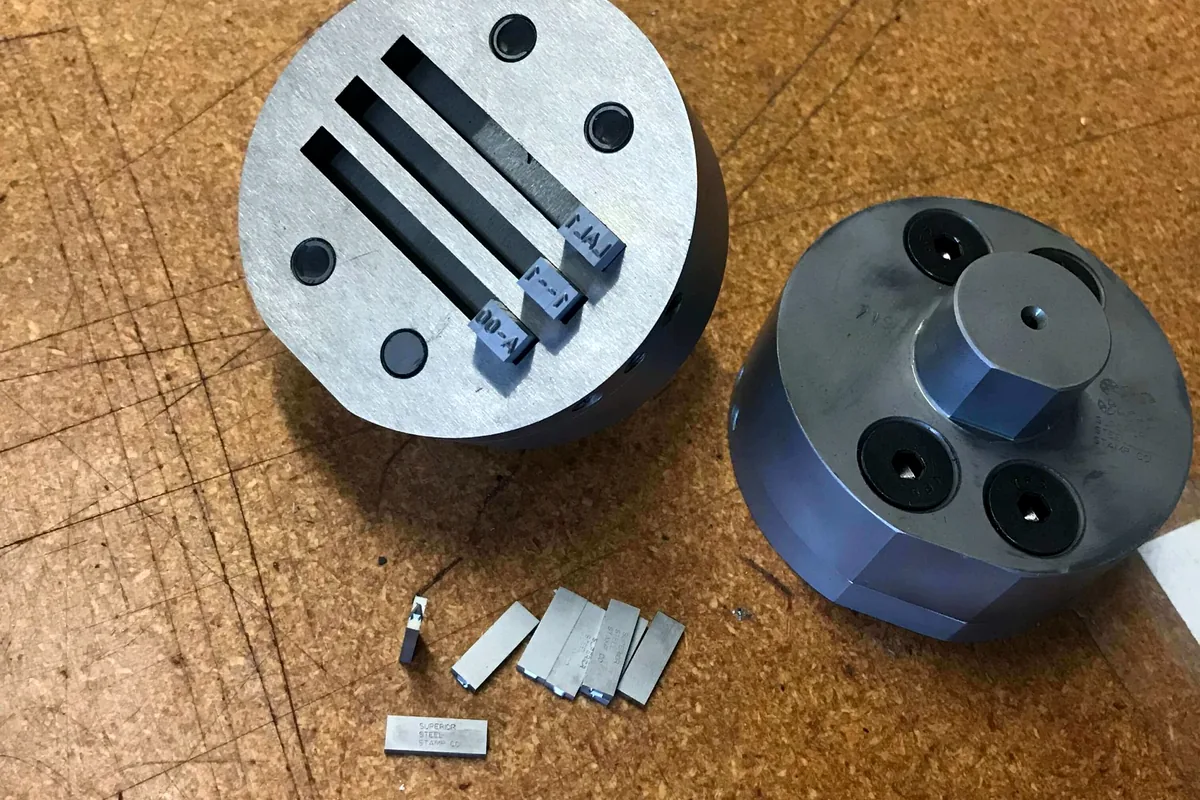 Multiple-line type holder photographed for press marking applications.